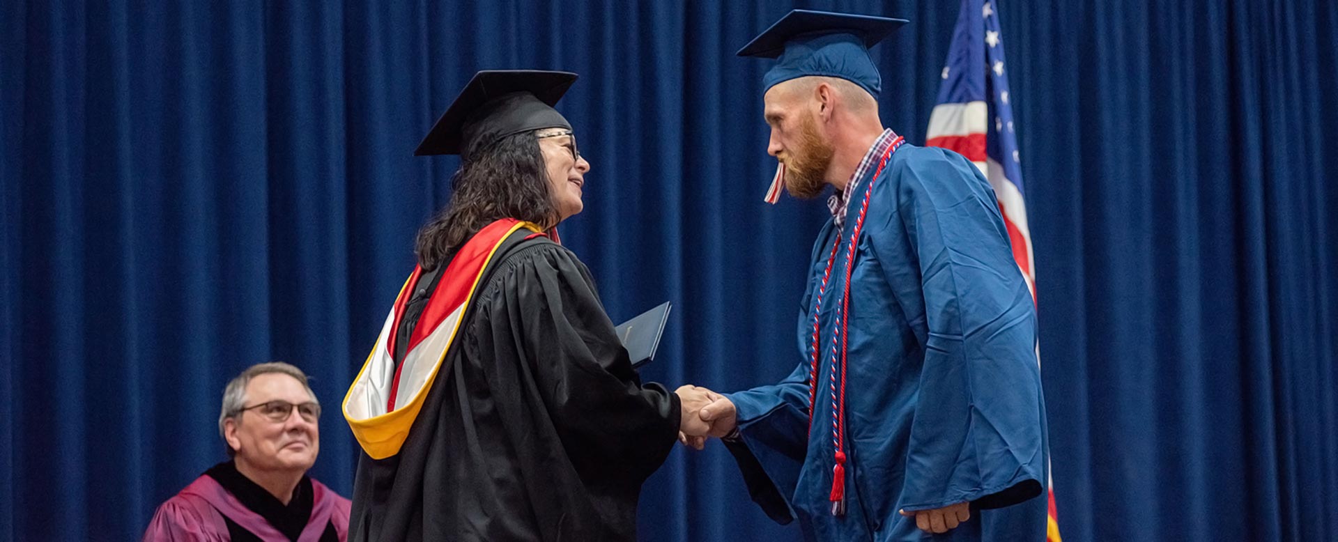 Veteran shaking the president's hand during SWCC graduation